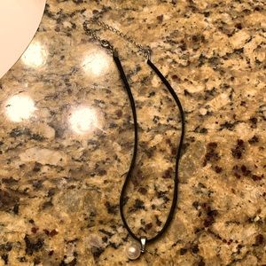 Necklace with a pearl on it